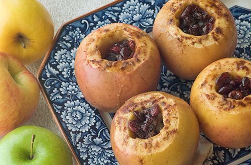 baked cored apples on plate with blue flowers 